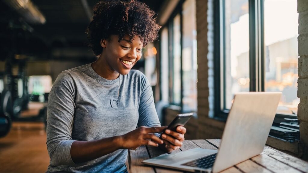 A person browsing a fitness website or app on their phone or laptop